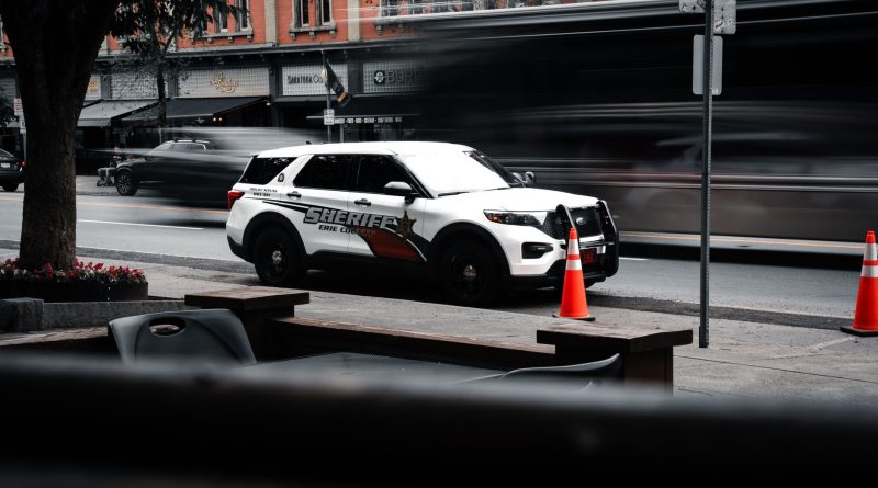 police car patrol city street