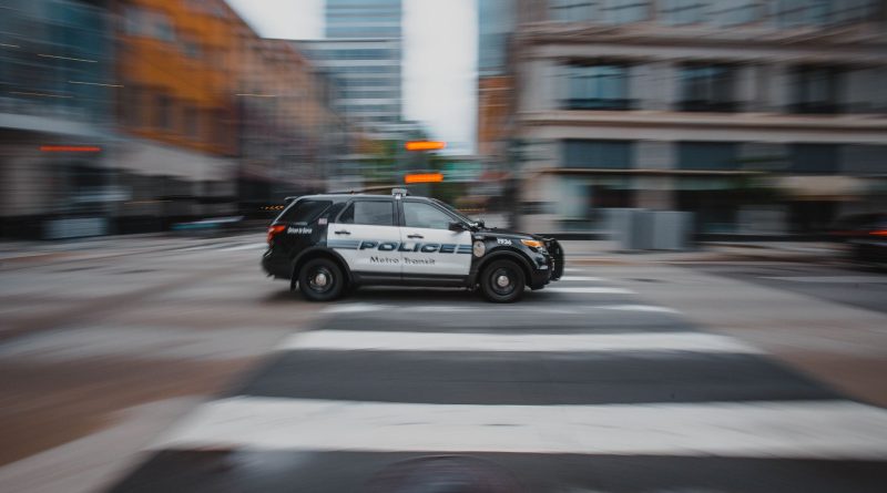 police car patrol city street